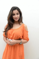 Actress Madhurima Cute in Orange Dress Photos Stills