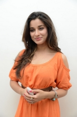 Actress Madhurima Cute in Orange Dress Photos Stills