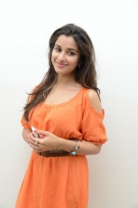 Actress Madhurima Cute in Orange Dress Photos Stills