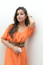 Actress Madhurima Cute in Orange Dress Photos Stills